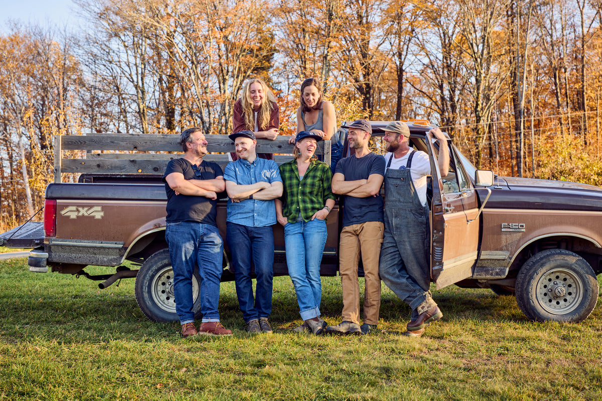 Field Company team gathered around a vintage pickup truck
