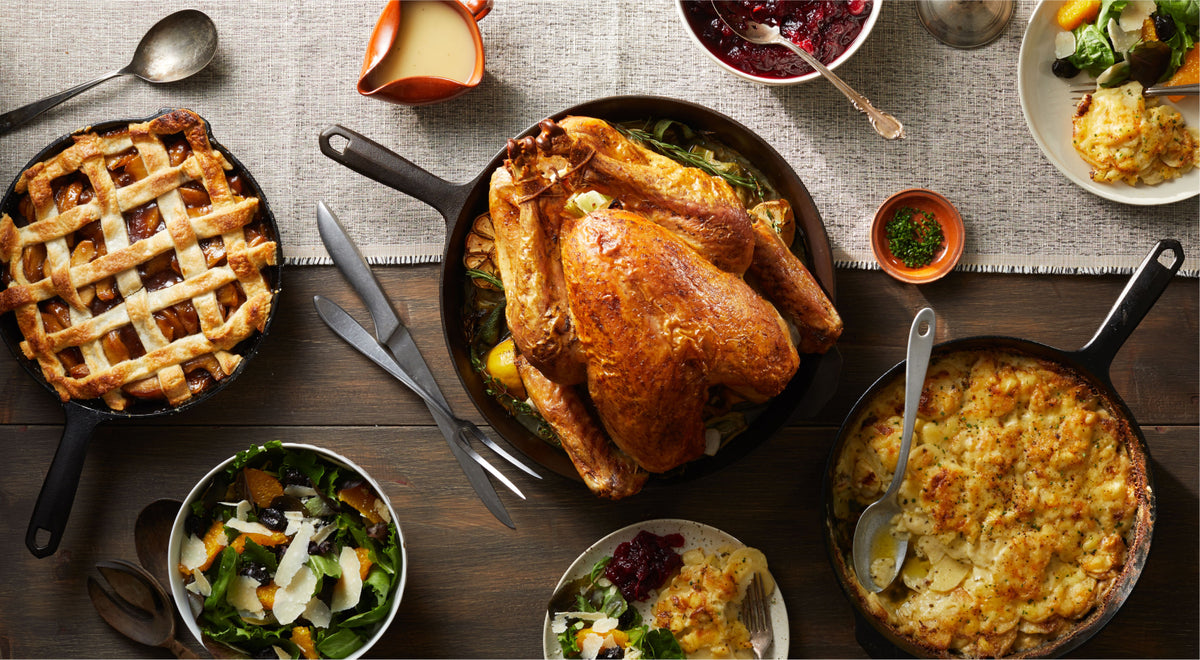 Thanksgiving spread with roast turkey, lattice apple pie, and potato gratin in Field Cast Iron Skillets